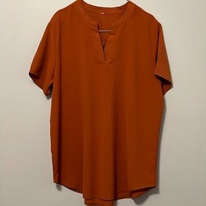 Women’s burnt orange work top.